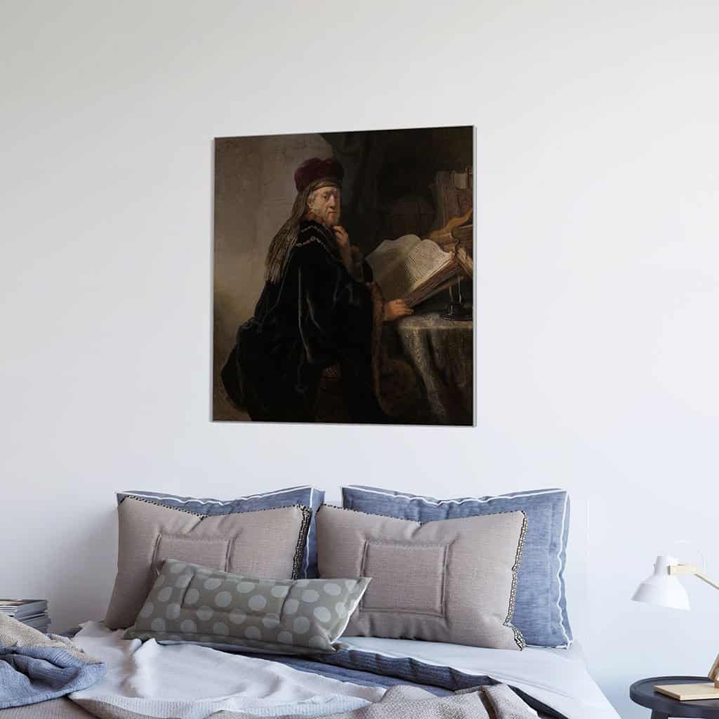 Geleerde, zittend aan een tafel met boeken (Rembrandt)
