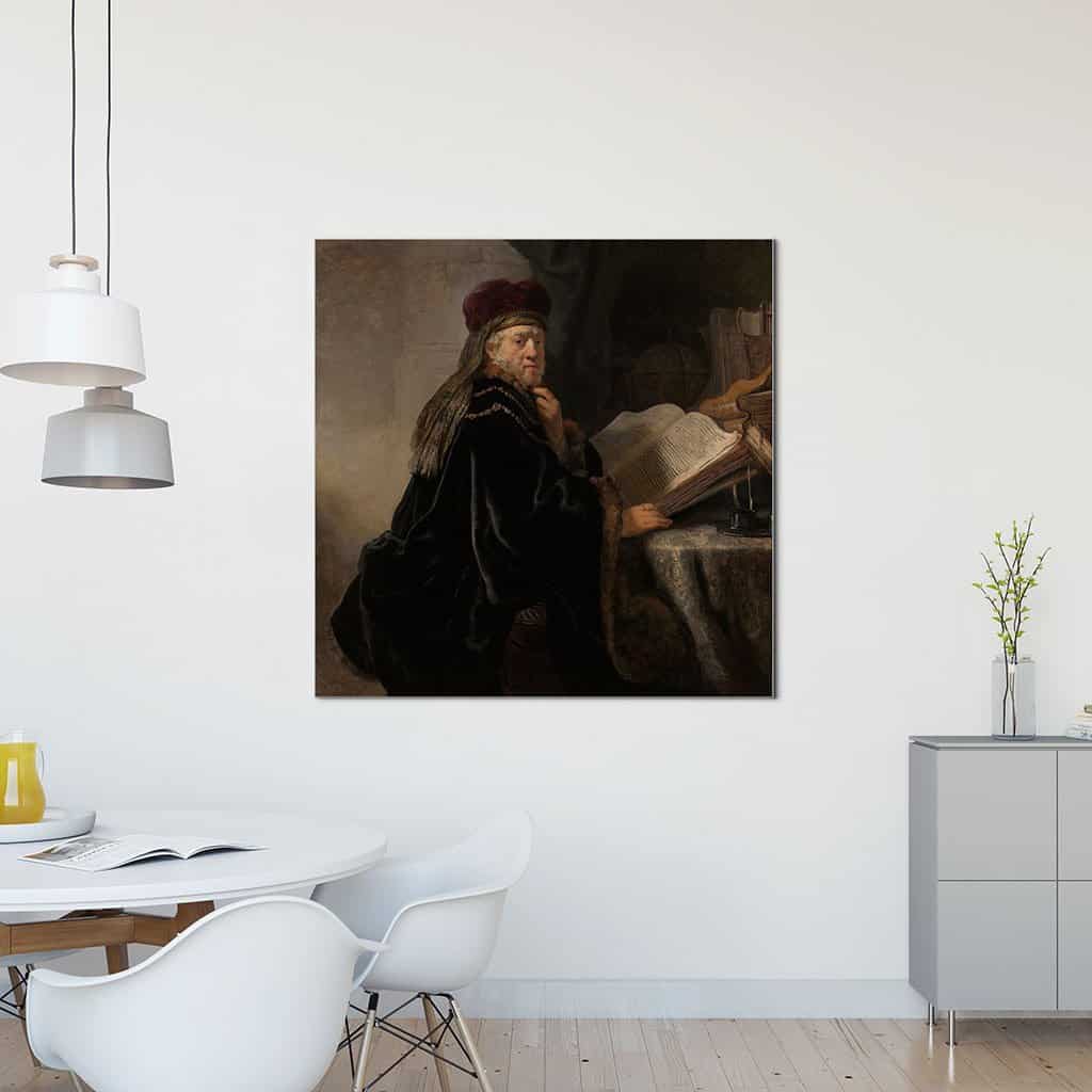 Geleerde, zittend aan een tafel met boeken (Rembrandt)