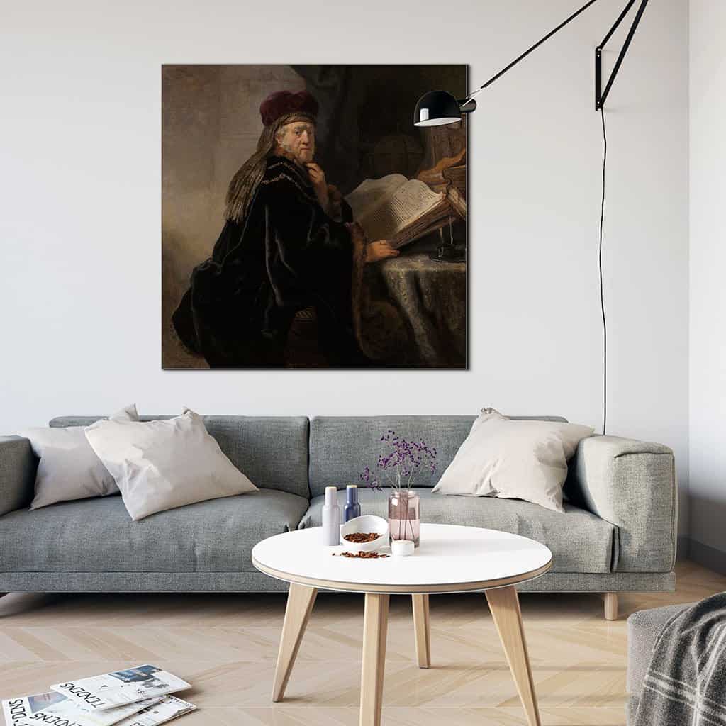 Geleerde, zittend aan een tafel met boeken (Rembrandt)
