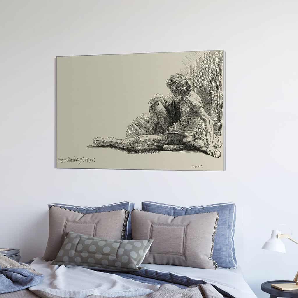 Jonge man, zittend op de vloer met een uitgestrekte been - Rembrandt