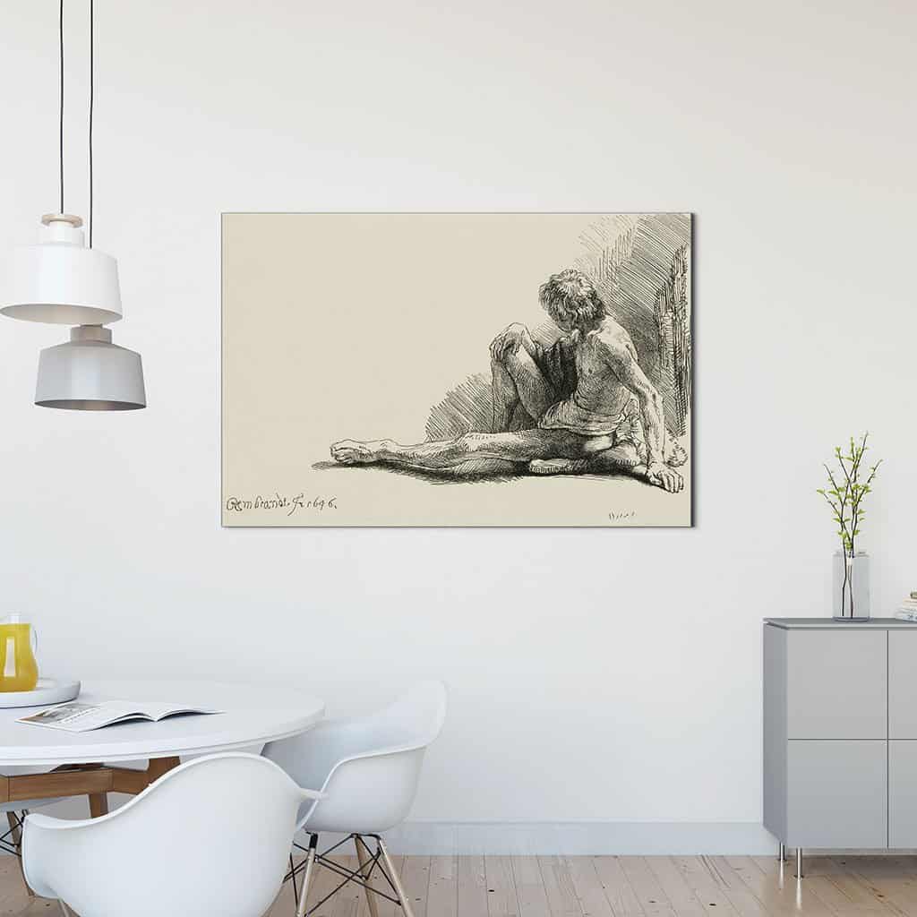 Jonge man, zittend op de vloer met een uitgestrekte been - Rembrandt