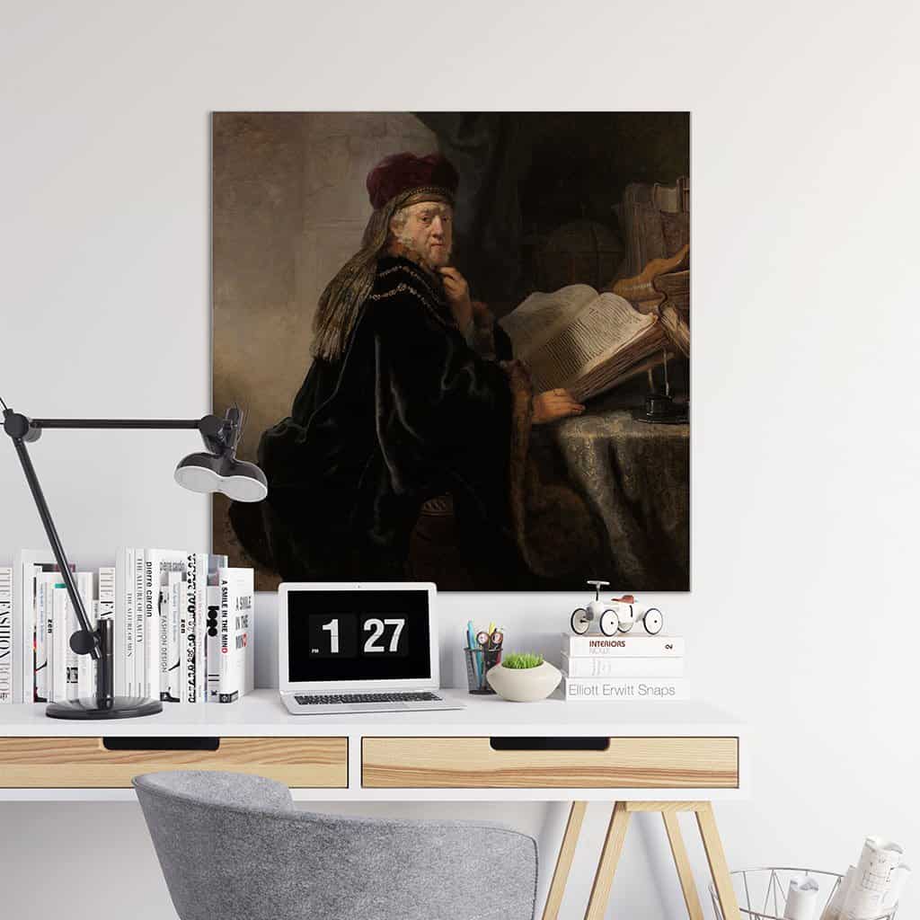 Geleerde, zittend aan een tafel met boeken (Rembrandt)