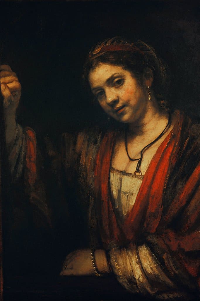 Vrouw bij een half open deur - Rembrandt